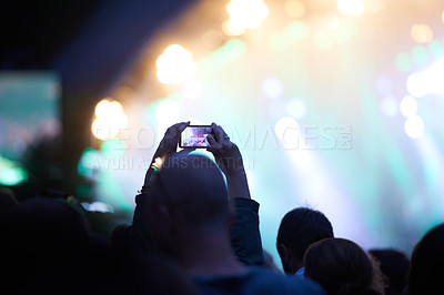 Buy stock photo Hands, cellphone and photography at music concert in crowd for social media post for holiday, carnival or night. Silhouette, photo and summer event or travel party or dark outdoor, lights or festival