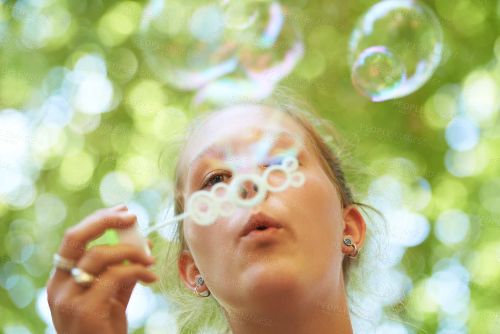 Buy stock photo Woman, bubbles and blowing outdoor for fun on weekend, break or holiday for relax and summer entertainment. Person, closeup and plastic wand or toy for playing and leisure on vacation or adventure