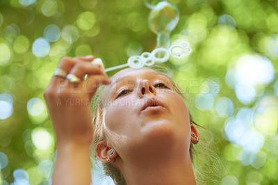 Buy stock photo Lady, game and bubbles of water and soap, freedom with happiness, summer and blurred background. Outdoors, gen z and play in park for peace and activity with wand in sunshine, calm and nature