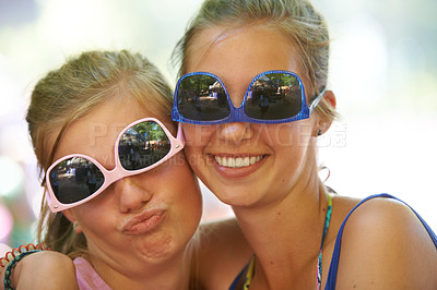 Buy stock photo Women, sunglasses and silly portrait at festival in nature, excited and reunion for bonding together. Friends, funny face and relax for celebration in summer on holiday and care at concert outdoor