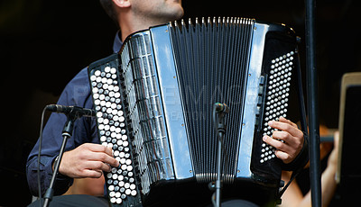 Buy stock photo Person, accordion and music concert or live performance for audio entertainment with band for show, festival or song. Artist, hands and playing instrument at sound event for carnival, jazz or folk