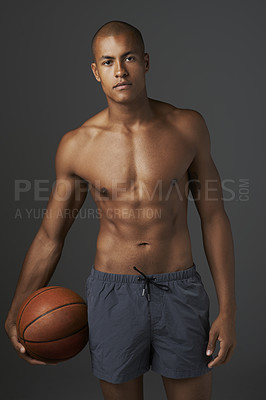 Buy stock photo Portrait, basketball and sports with body of man in studio on dark background for fitness or training. Exercise, workout or game and confident young athlete, shirtless with ball for competition