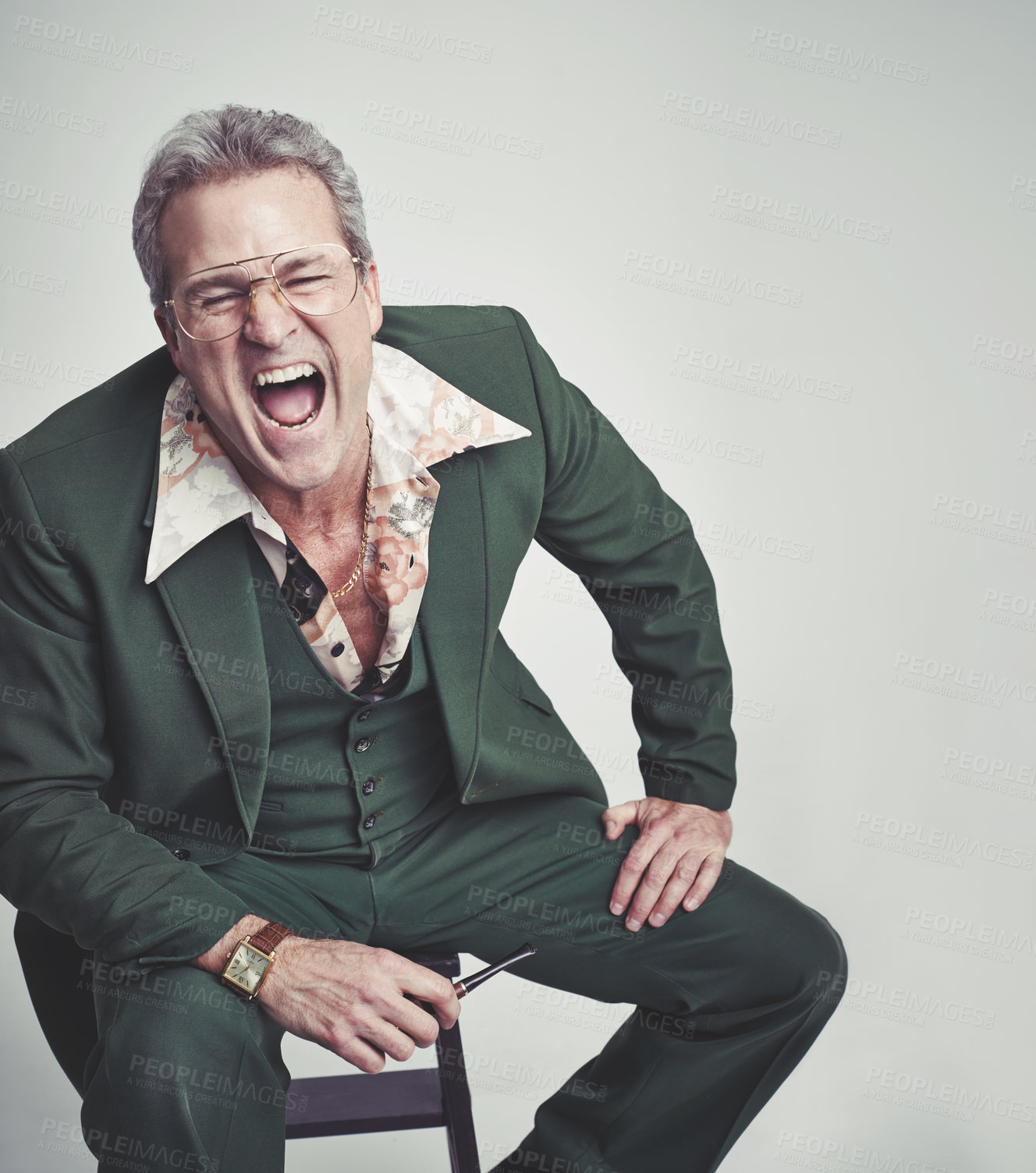 Buy stock photo Retro, fashion and mature man shouting in studio with mockup space, groovy suit and pipe. Funky clothes, screaming and person with vintage style on chair, unique and excited on white background.