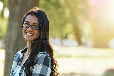 Buy stock photo Woman, portrait and relaxing in park or garden, smiling and joyful on summer holiday. Female person, eyewear and enjoying vacation in countryside, outdoors and calm student on weekend in nature
