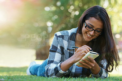 Buy stock photo Writing, grass or happy woman in park with notes for learning knowledge, information or education. Smile, diary journal or student in nature for studying idea or peace on college campus lawn to relax