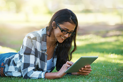 Buy stock photo College, woman and typing on tablet in park with research, project or learning outdoor on campus. University, student and girl reading online with ebook, education and studying on grass in garden