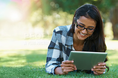 Buy stock photo College, woman and reading on tablet in park with research, project or learning outdoor on campus. University, student and girl streaming online with ebook, education and studying on grass in garden
