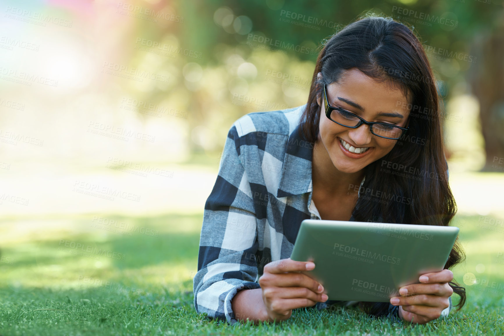 Buy stock photo College, woman and reading on tablet in park with research, project or learning outdoor on campus. University, student and girl streaming online with ebook, education and studying on grass in garden