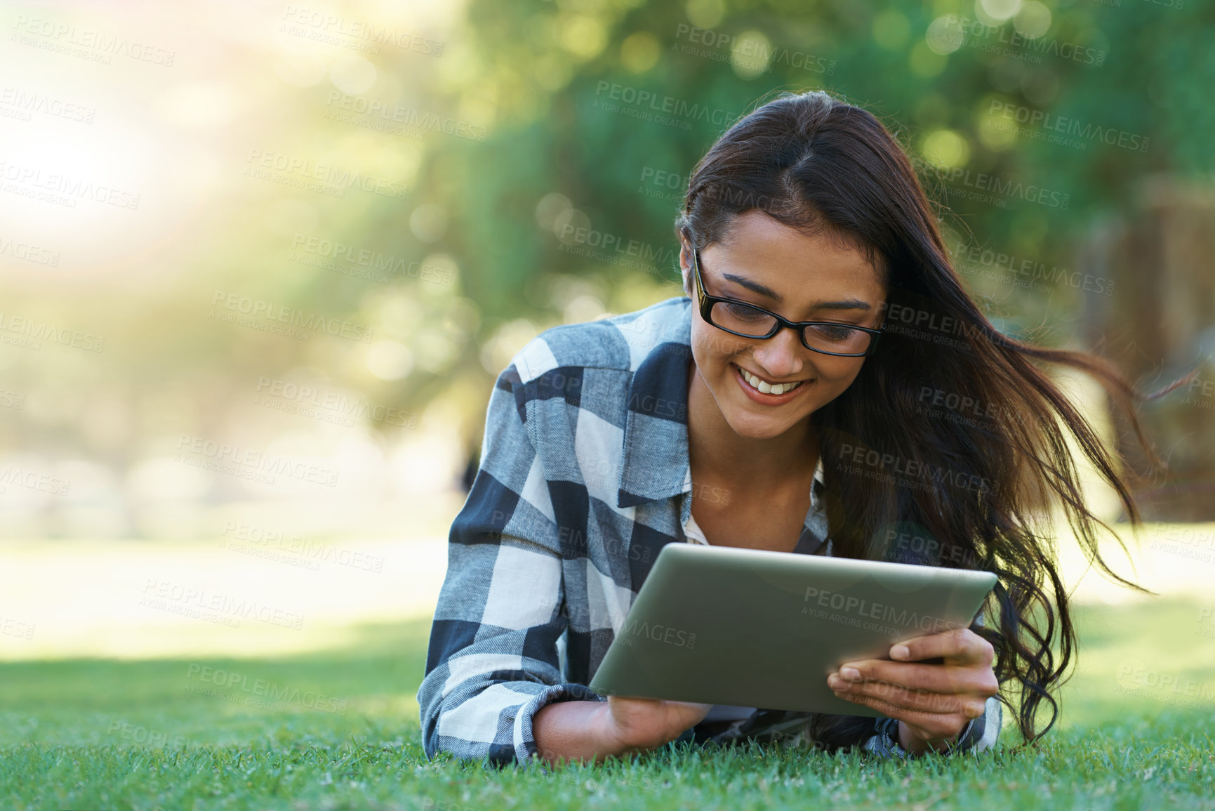 Buy stock photo Young woman in a park with her laptop