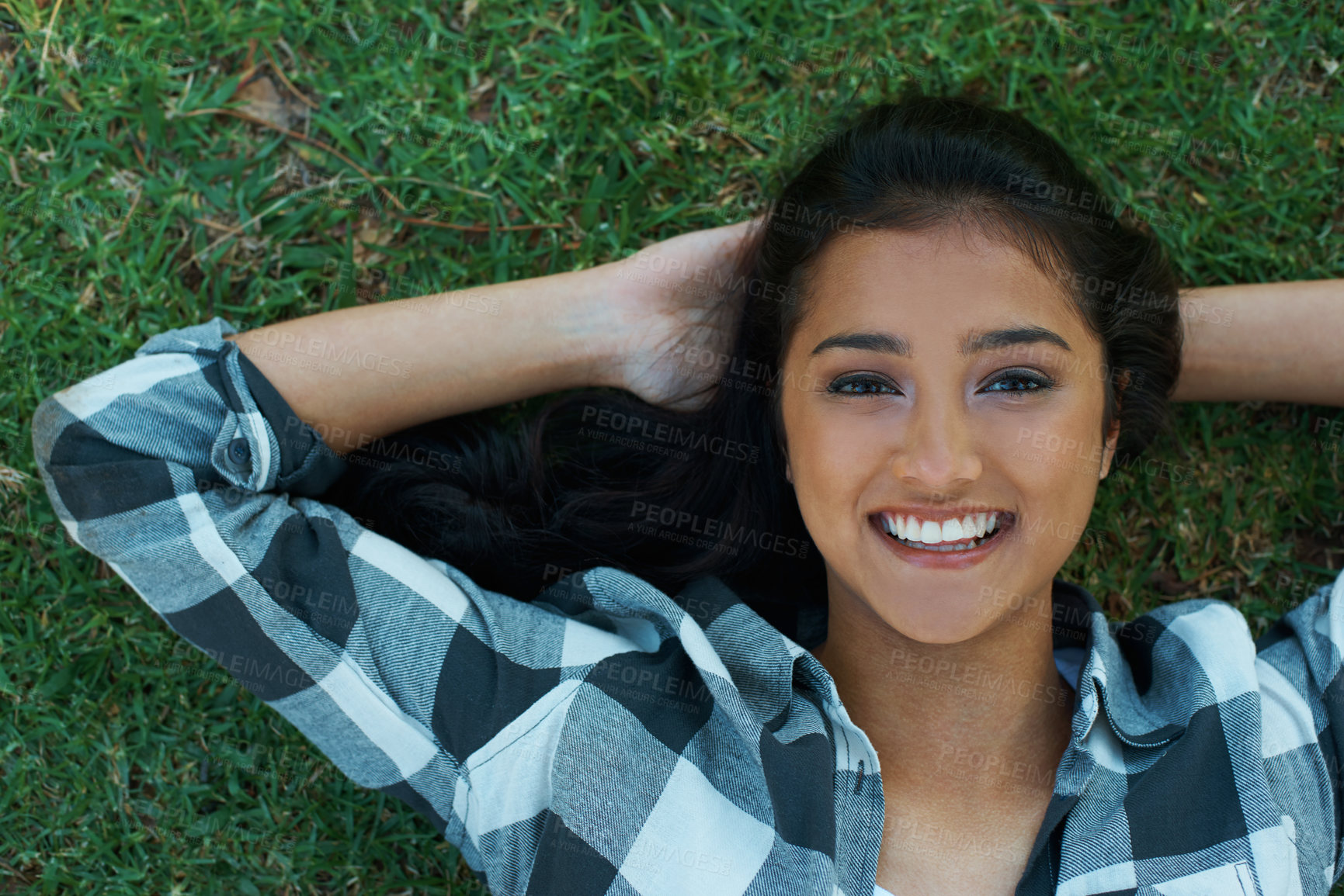 Buy stock photo Nature, grass and woman happy in portrait, smiling and relaxed on vacation in Dubai for peace. Female person, resting and enjoyment for holiday on outdoor lawn, adventure and travel to countryside