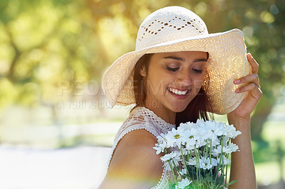 Buy stock photo Woman, happy and flowers for relaxing in park or garden, smile and travel on summer holiday. Female person, peace and enjoy vacation in countryside, outdoors and hat on weekend adventure in nature