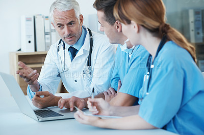 Buy stock photo Laptop, meeting and doctor with nurses in hospital for medical diagnosis or treatment discussion. Team, computer and senior surgeon talking to healthcare workers for surgery research in clinic.