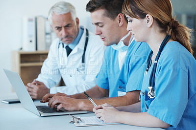 Buy stock photo Computer, meeting and doctor with nurses in hospital for medical diagnosis or treatment discussion. Team, laptop and senior surgeon talking to healthcare workers for surgery research in clinic.