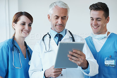 Buy stock photo Tablet, meeting and doctor with nurses in hospital for medical diagnosis or treatment discussion. Team, digital technology and senior surgeon talk to healthcare workers for surgery research in clinic