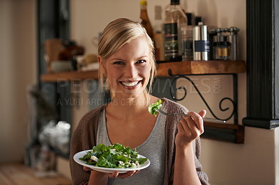 Buy stock photo Young, woman and eating a salad in kitchen with a smile with wellness and lettuce for cooking. Girl, healthy and vegetables on plate for nutrition or diet in house with hungry person in the usa.