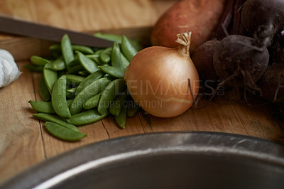 Buy stock photo Vegetables, onion and wooden board for cooking lunch, dish and nutrition for diet at home. Wellness, health and organic food with meal, vegetarian and green ingredients for vegan salad in a kitchen
