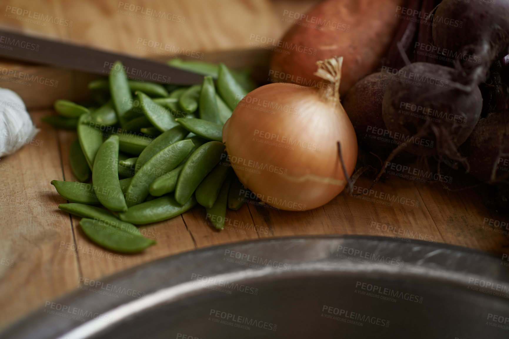 Buy stock photo Vegetables, onion and wooden board for cooking lunch, dish and nutrition for diet at home. Wellness, health and organic food with meal, vegetarian and green ingredients for vegan salad in a kitchen