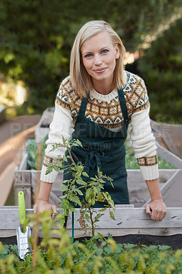 Buy stock photo A beautiful young woman gardening outside