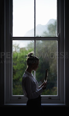 Buy stock photo Woman, feather and window for writer in home for idea and creative with author, inspiration and learning. Female artist, writing and shadow with thinking, fashion and mysterious editor for literature