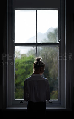 Buy stock photo A beautiful young woman standing by a window