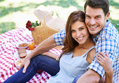 Buy stock photo Portrait, love and happy couple with picnic in the park to celebrate valentines day vacation. Face, smile and man with woman hugging for affection and bonding with food and flowers on nature holiday