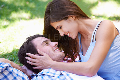 Buy stock photo Man, woman and relax on grass in park for holiday in summer bonding or weekend, happiness or outdoor. Happy couple, smile and embrace on lawn or together for dating connection or rest, love or London