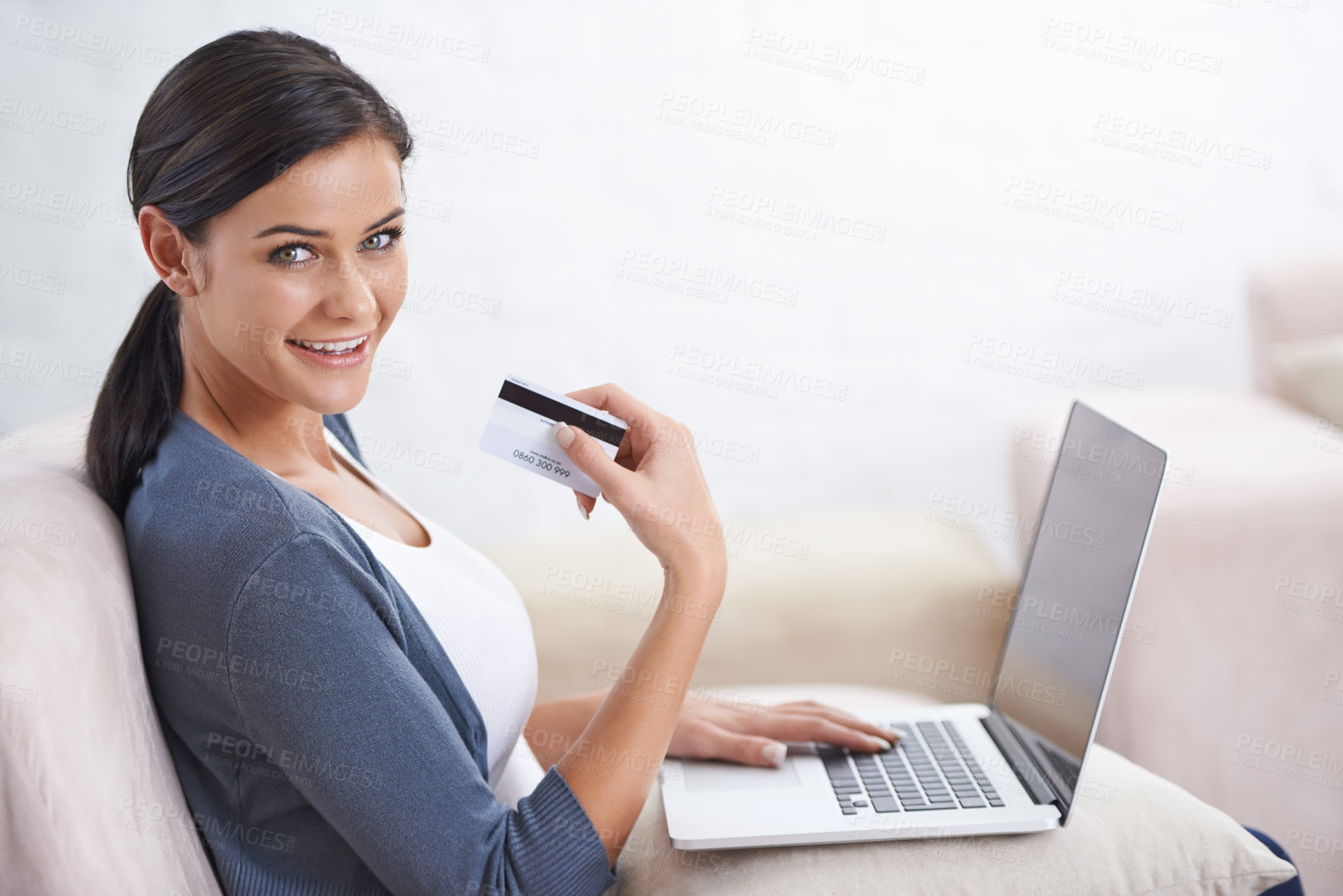 Buy stock photo Shot of a young woman doing some online shopping