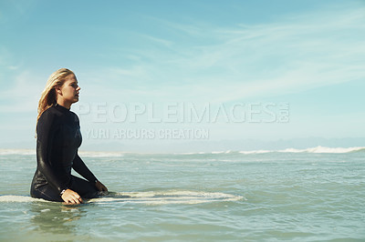 Buy stock photo Sports, space and woman in ocean on surfboard to relax with sports, fitness or exercise in summer. Nature, sea and wave with confident young surfer person on blue sky for vacation, holiday or balance