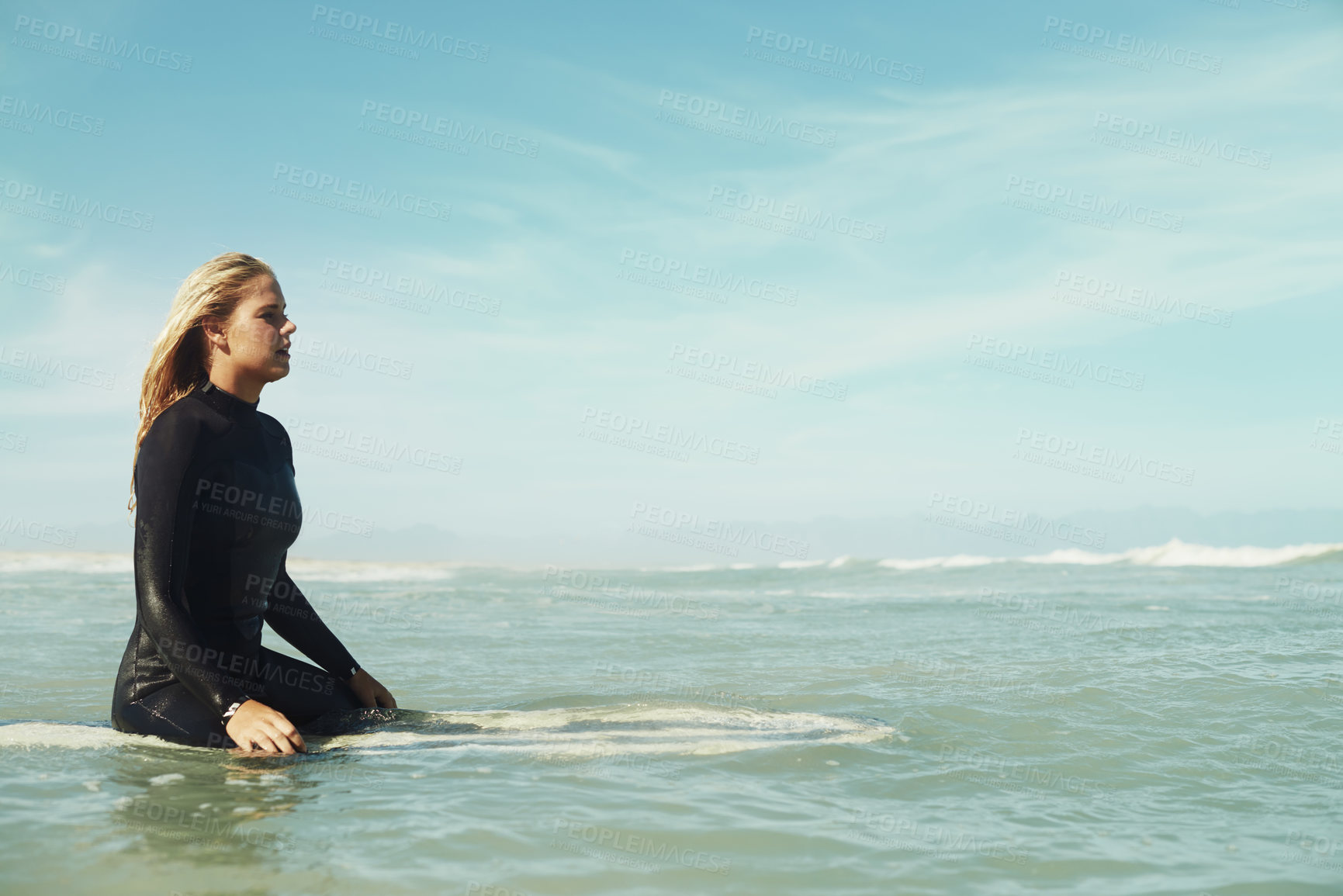 Buy stock photo Sports, space and woman in ocean on surfboard to relax with sports, fitness or exercise in summer. Nature, sea and wave with confident young surfer person on blue sky for vacation, holiday or balance