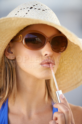 Buy stock photo Closeup, portrait and woman with lip gloss for beauty, makeup and glow during hot summer day. Female person, tourist and cosmetics with glossy lipstick, straw hat, and sunglasses in Portugal