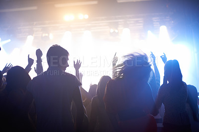 Buy stock photo Music, lighting and people at concert, dancing and energy at festival from back together at live event. Dance, fun and group of excited fans at stage arena or rock band performance and crowd at party