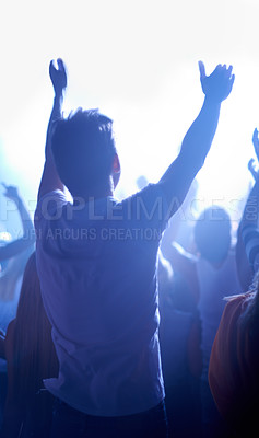 Buy stock photo Music festival, concert and man in crowd from back, dancing in neon lights and energy at live event. Dance, fun and excited fans in arena at rock band performance or audience at techno rave party.