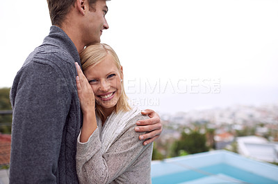 Buy stock photo Couple, portrait and happy with hug outdoor in city for holiday, vacation or anniversary getaway on balcony. Love, man and woman with face, smile and embrace in nature for relationship, care or relax