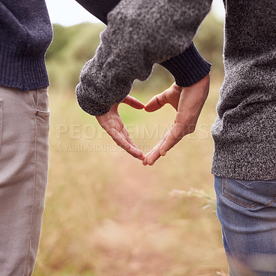 Buy stock photo Heart hands, love and couple in the countryside together for hiking, romance or adventure closeup. Nature, emoji or symbol with man and woman dating outdoor for anniversary or honeymoon from back