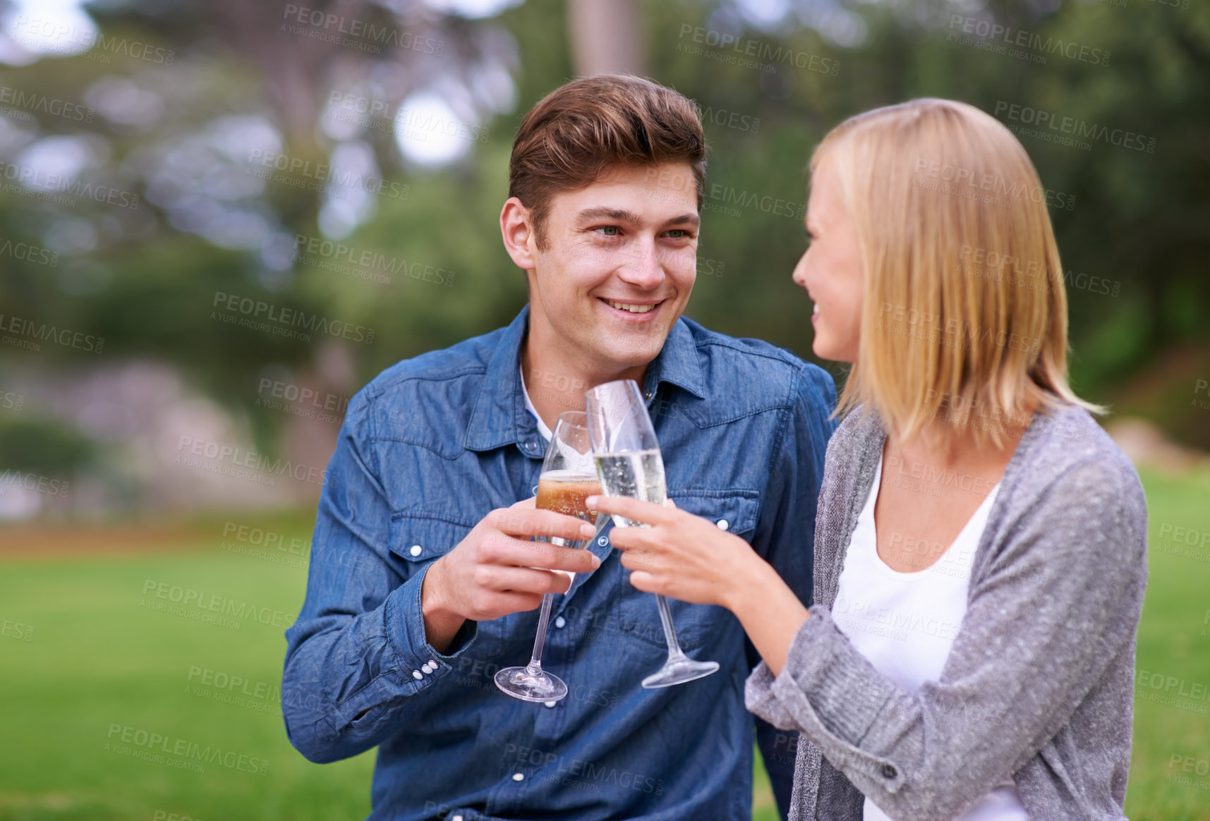 Buy stock photo Park, picnic and cheers with couple, love and celebration with happiness and bonding together for Valentines day. Outdoor, man and woman with champagne and anniversary with romance and countryside