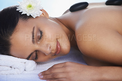 Buy stock photo Sleeping, hot stone or woman with flower in spa for wellness, treatment or hospitality. Relax, resort or salon with female person, client or masseuse in hotel on holiday vacation for beauty therapy 