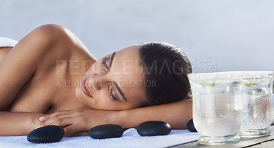 Buy stock photo Sleeping, hot stone or woman in spa with beauty or flower for wellness, treatment or hospitality. Relax, resort or healing therapy for happy person, client or masseuse in hotel on holiday vacation 