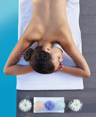 Buy stock photo A young woman lying on her front and waiting for her massage therapist