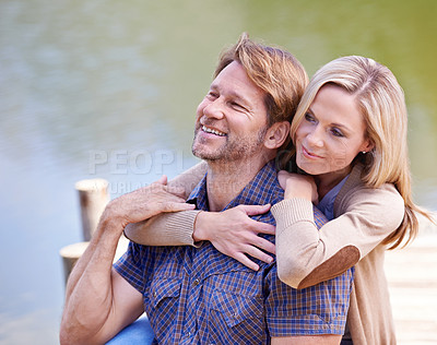 Buy stock photo Mature couple, happiness and vacation in lake, countryside and commitment with love in marriage. Anniversary, smile and hug by partner, family and woman with man on dock for sightseeing in nature