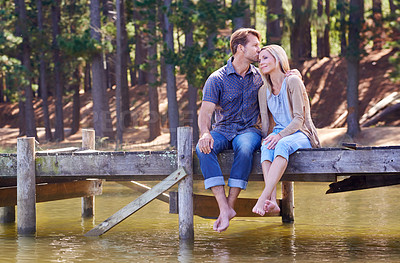Buy stock photo A loving married couple enjoying a moment on the jetty at the lake