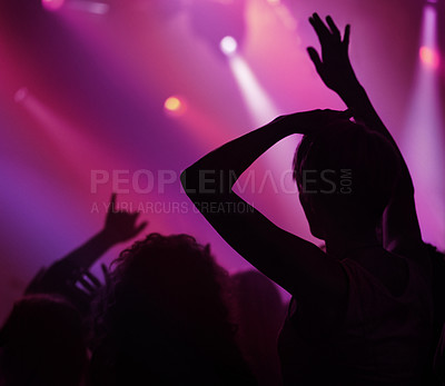 Buy stock photo Neon, light and people dancing at concert or music festival, energy in silhouette at live show event. Dance, fun and purple lighting at party, group of excited fans in arena at rock band performance.