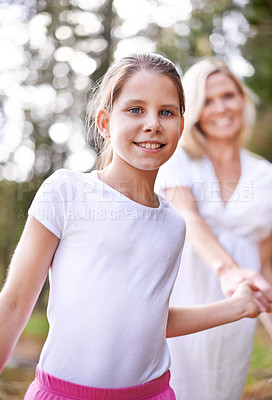 Buy stock photo Girl, child and portrait outdoor with happiness for bonding, support or holding hands with mother on holiday in nature. Family, woman or daughter with face, smile or trust on vacation, travel or love