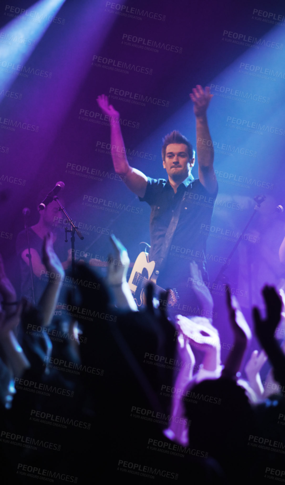Buy stock photo People hands, music and singer at concert in night performance, rock band or gen z in neon lights or cheers. Musician man on stage at disco event and fans clapping, crowd or audience dancing on floor