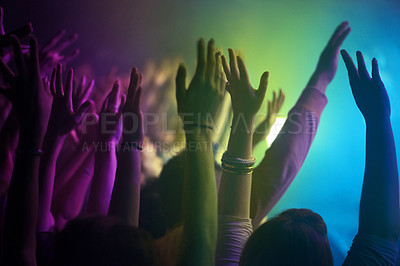 Buy stock photo Hands, neon and lighting for people at concert dancing, music festival or crowd with energy at night event. Dance, fun or group of excited fans in arena, rock band performance and disco color party