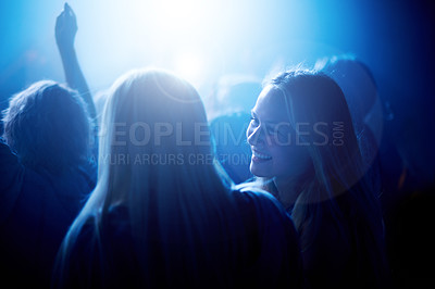 Buy stock photo Smile, women in crowd at music festival and blue lighting, happiness at live concert event. Dance, fun and group of excited, fans in arena at rock band performance or happy woman and friends at party