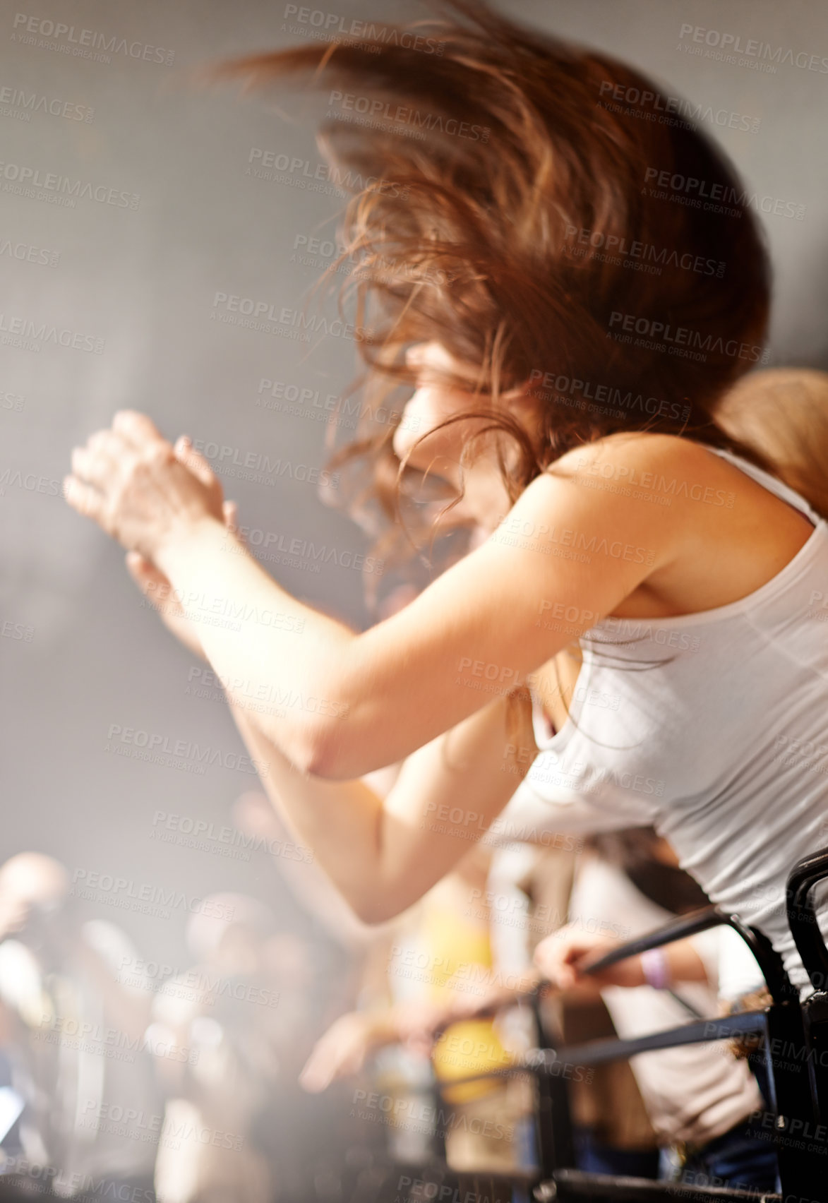 Buy stock photo Dance, woman in fence row and music festival, fan watching rock concert or live event on stage. Girl dancing in crowd, excited fans at band performance and head banging in arena or stadium at show