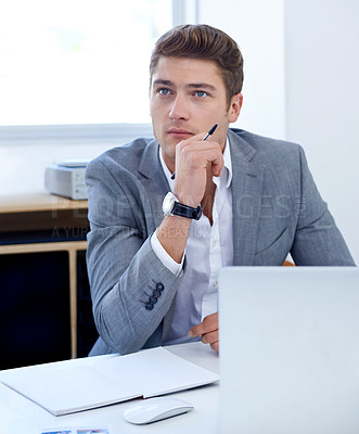 Buy stock photo A thoughtful young businessman at his desk