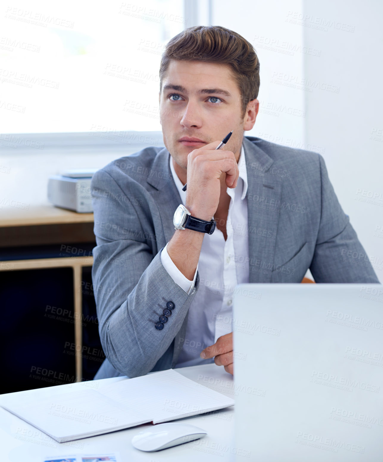 Buy stock photo A thoughtful young businessman at his desk