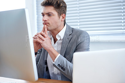 Buy stock photo A handsome young executive working in his office