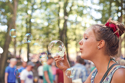 Buy stock photo Party, bubbles and music with woman at festival in forest for celebration, summer and performance. Carnival, culture and concert with female in nature for dancing, rave show and techno event